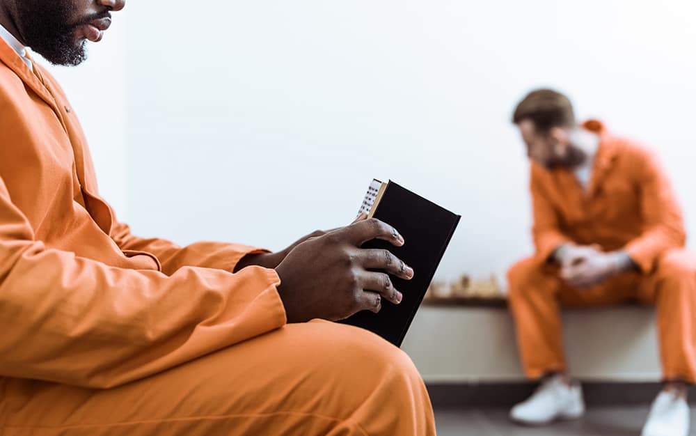 An inmate reading a book
